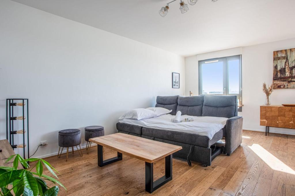 a living room with a couch and a table at Comfortable flat w views of Paris in Saint-Denis - Welkeys in Saint-Denis