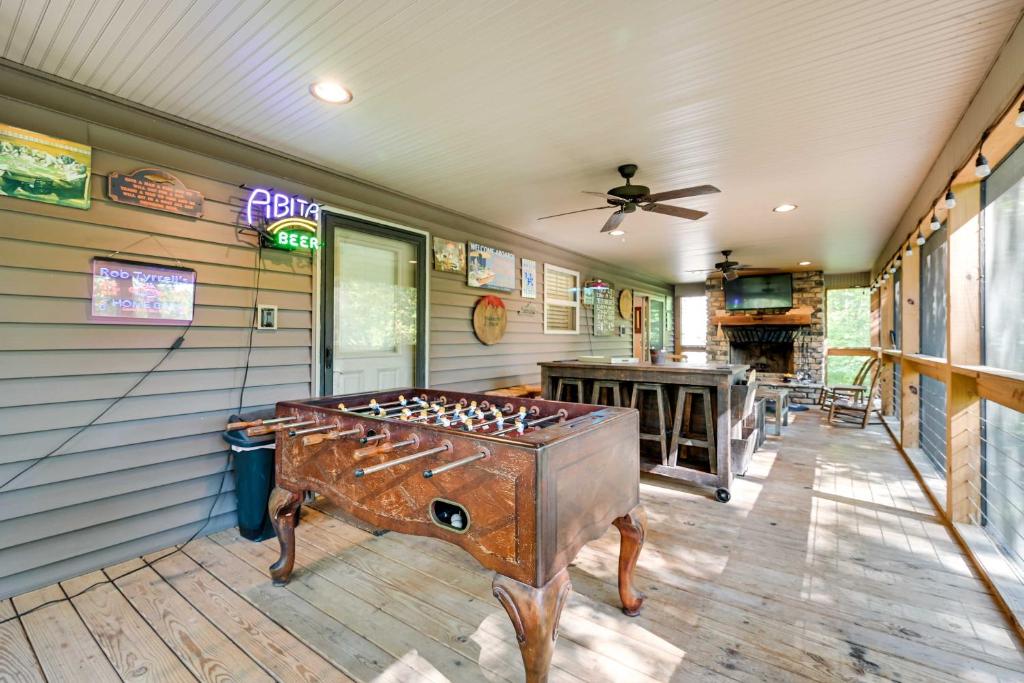 a room with a pool table and a ceiling fan at Nolin Lake Home with Hot Tub 15 Mi to Mammoth Cave! in Cub Run