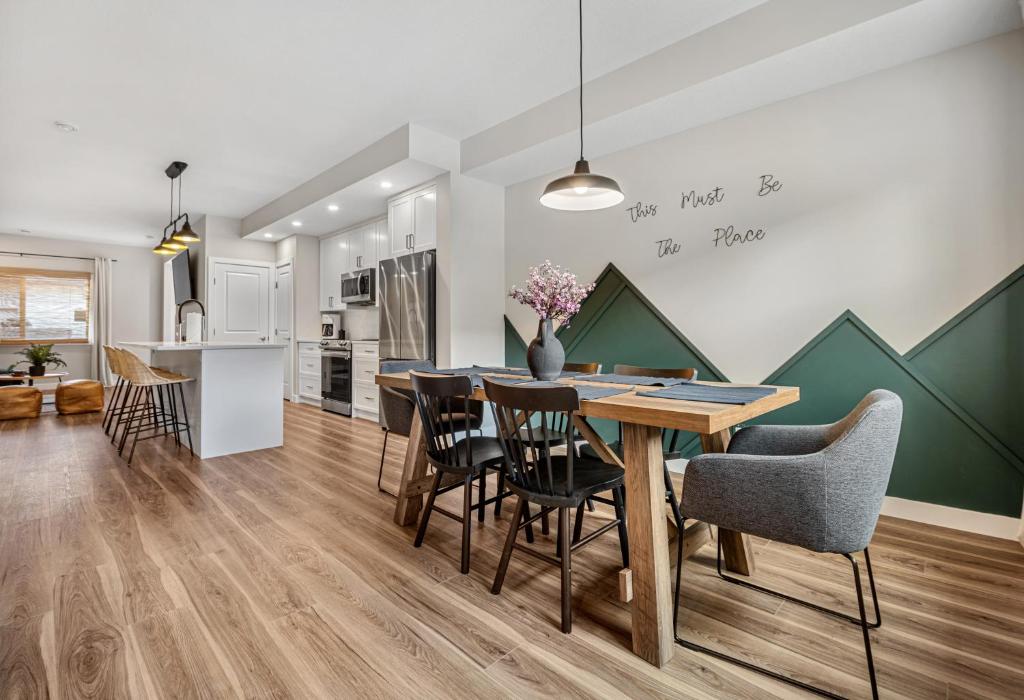 a kitchen and dining room with a table and chairs at Serene Peaks, Private Hot Tub, Peaceful in Radium Hot Springs