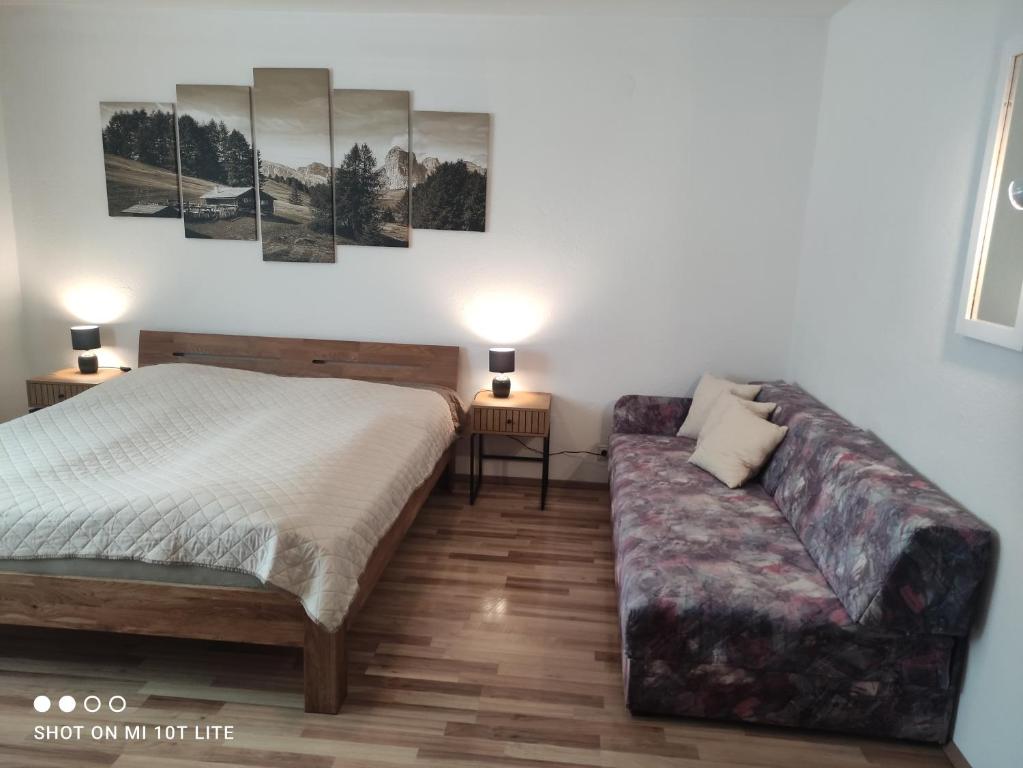 a bedroom with a bed and a couch at groassehof Haus Gstrein in Imsterberg