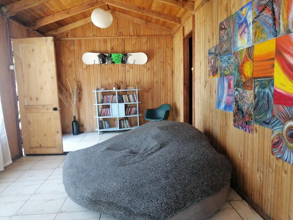 ein Zimmer mit einem Stuhl und einem Gemälde an der Wand in der Unterkunft CASA kuntur in Cajon del Maipo