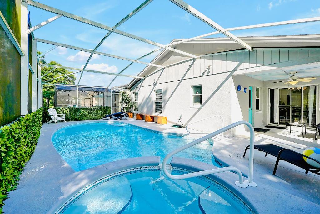 a swimming pool in the backyard of a house at Stunning Retreat with Pool, Hot Tub, Patio, King Bed in Kissimmee