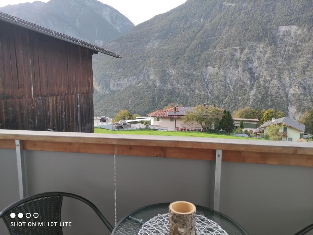 a cup of coffee sitting on a table on a balcony at groassehof Haus Gstrein in Imsterberg
