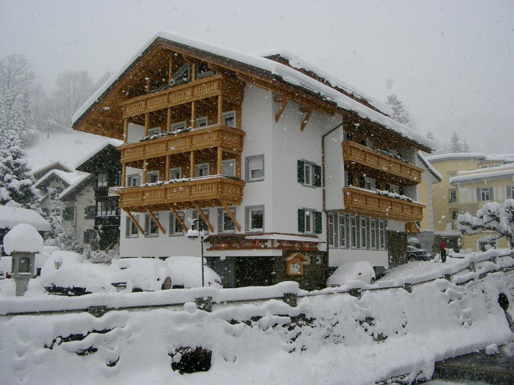 a house covered in snow in front at Apparthotel Litz in Schruns-Tschagguns