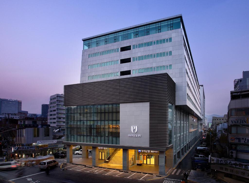 a tall building with a sign on the side of it at Hotel PJ Myeongdong in Seoul