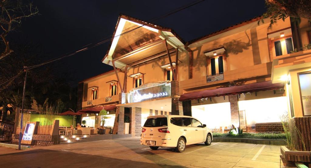 a white van parked in front of a building at night at Syailendra Hotel Syariah in Jepara