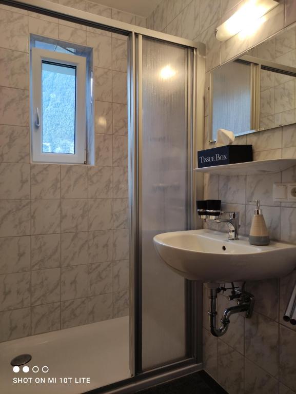 a bathroom with a sink and a shower at groassehof Haus Gstrein in Imsterberg