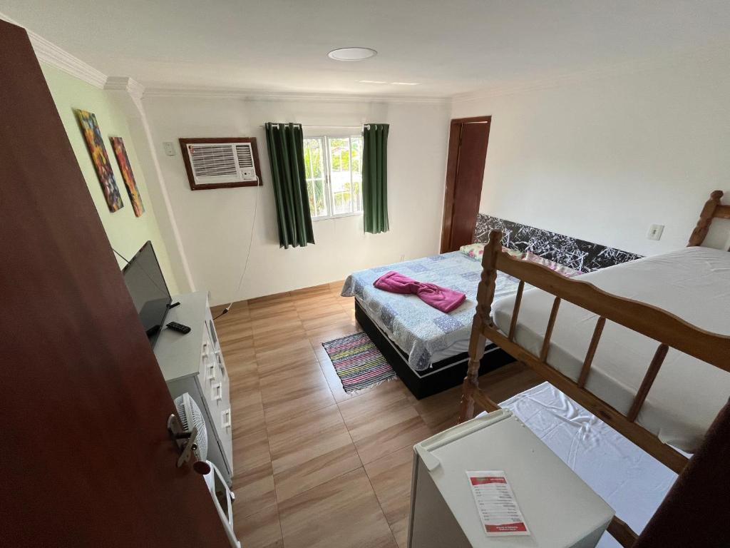 a room with a bed and a bunk bed at Hotel Marquês de Maricá in Maricá