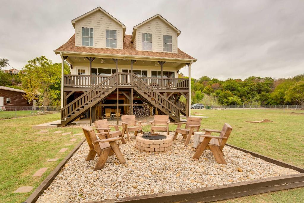 a house with a fire pit in the yard at Lake Granbury Fishing Escape with Dock and Kayaks! in Granbury