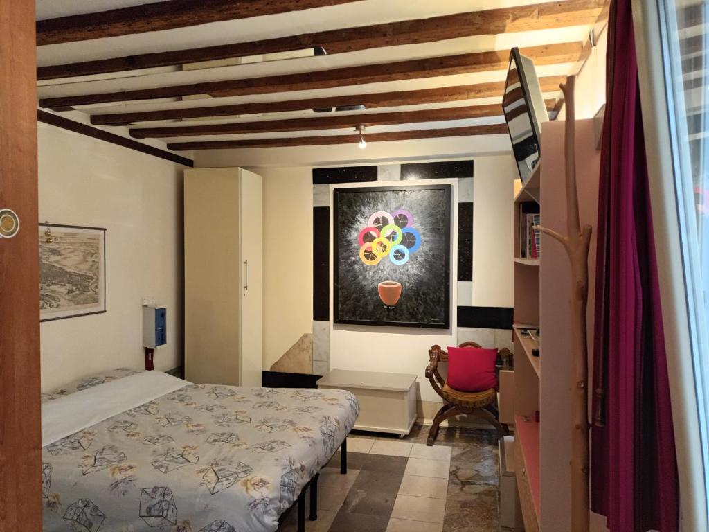 a bedroom with a bed and a painting on the wall at Tiepolo's Apartment in Venice