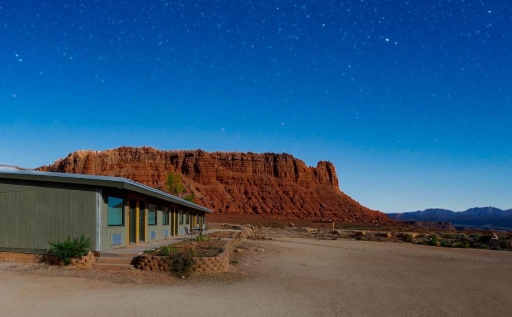 a building in the desert with a mountain in the background at Marble Canyon Lodge in Marble Canyon