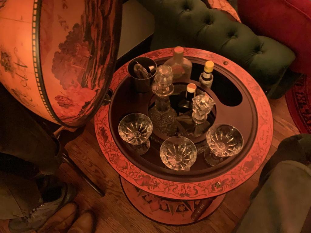 a table with wine glasses and wine bottles on it at Dr. Yaple's Art Deco House in Lafayette