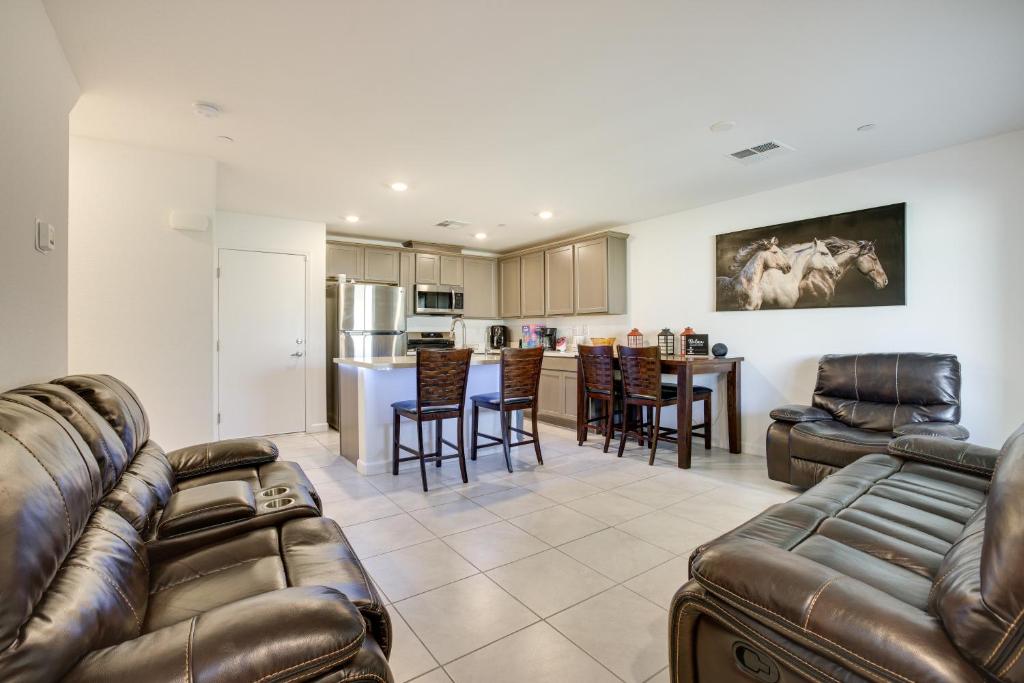 a living room with leather furniture and a kitchen at Comfy Las Vegas Retreat about 7 Mi to The Strip! in Las Vegas