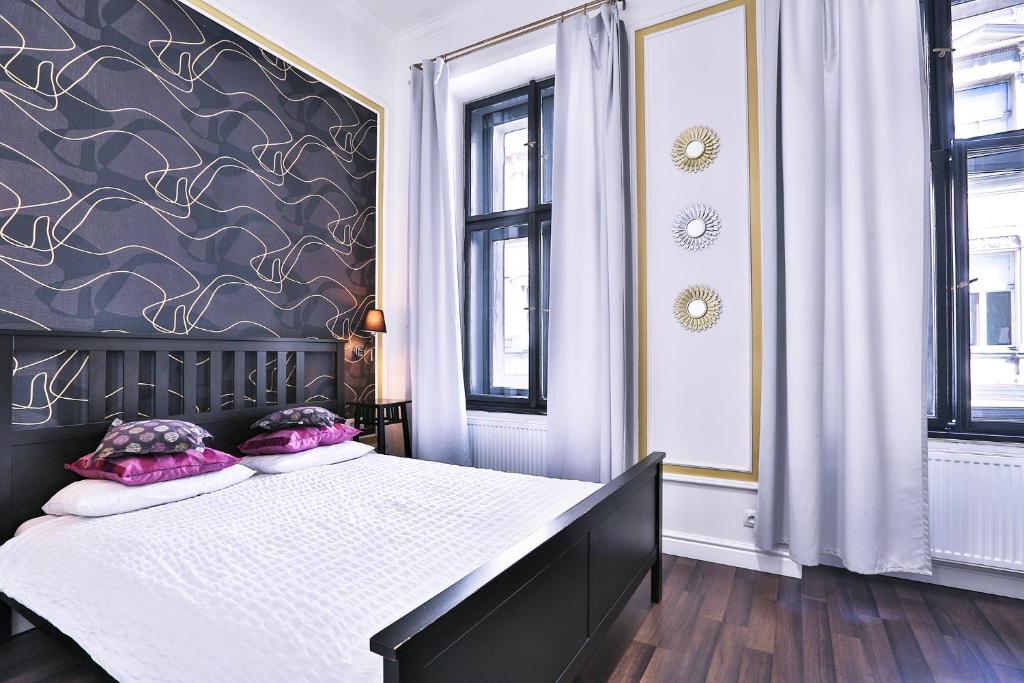 a bedroom with a large bed with purple walls at Two-bedroom Haven In The Old Town in Prague