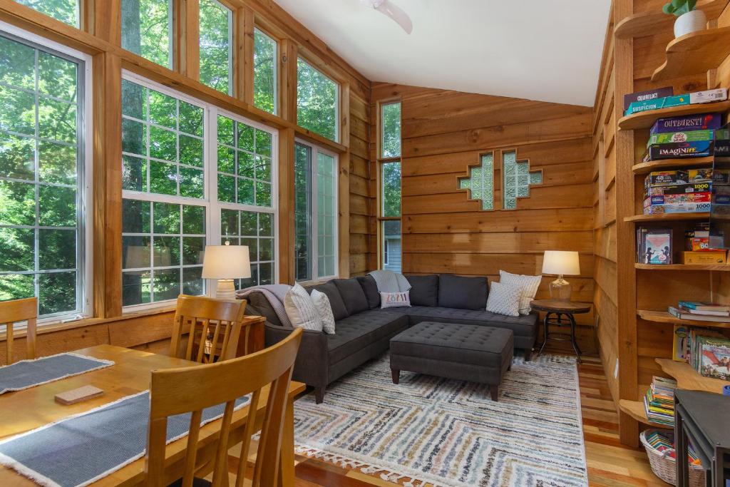 ein Wohnzimmer mit Couch und Tisch in der Unterkunft Charming Pet-Friendly Cottage Walkable to Town! in Black Mountain