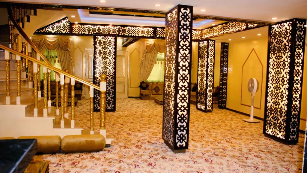 a lobby with a staircase and a stair case at The Zabeel Palace Villa in Karachi