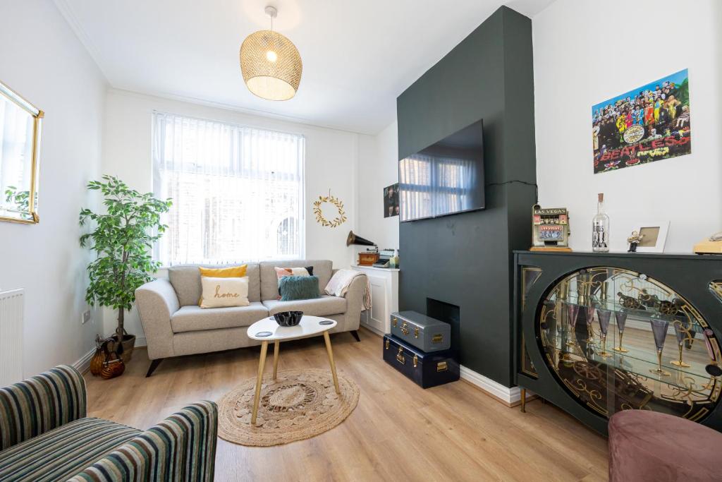 a living room with a couch and a fireplace at Air Host and Stay - Earp House 3 bedroom, sleeps 7, mins from train in Liverpool