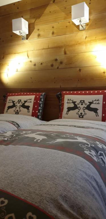 a bedroom with a bed with two pillows on it at Baita Filomena in Livigno