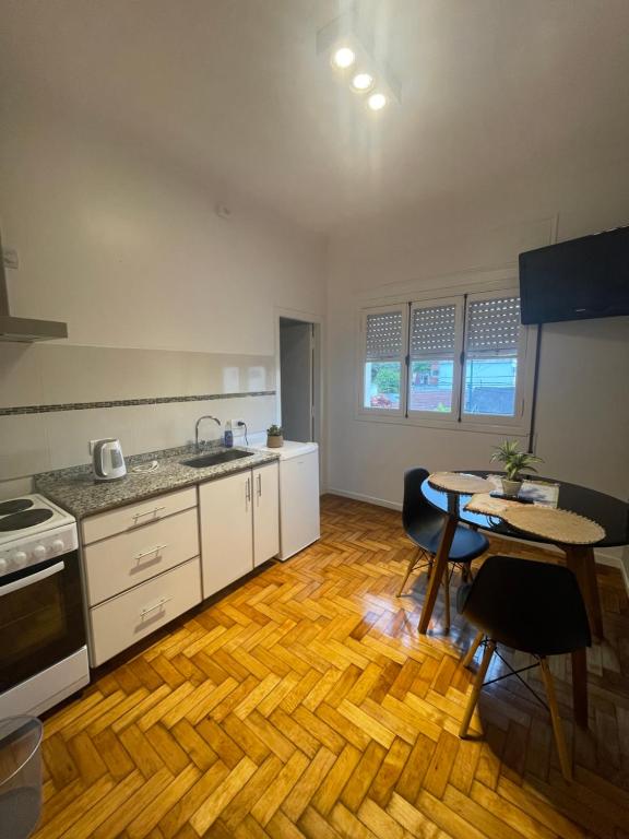 a kitchen with a table and a counter top at Ana rent in Boulogne