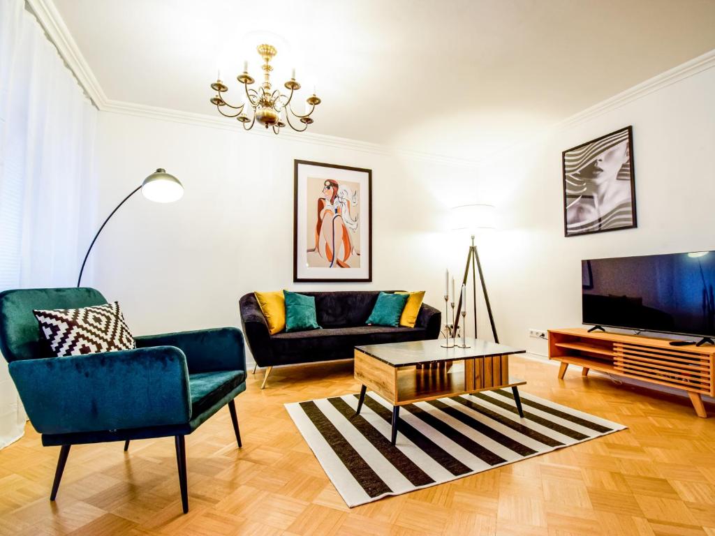 a living room with a couch and a tv at SCANDIC-Apartment, Balkony, Free Coffee, 80m2 in Pforzheim