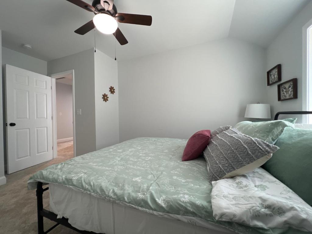 a bedroom with a bed with a ceiling fan at 5BR 4B Huge Space with 2 Level Game Barn in Greenville