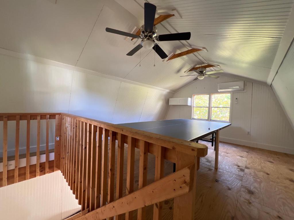 a dining room with a table and a ceiling fan at 5BR 4B Huge Space with 2 Level Game Barn in Greenville