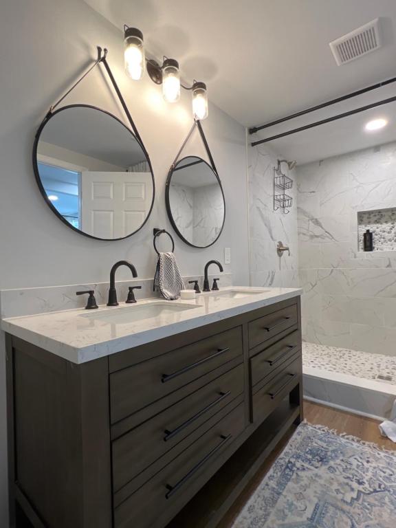 a bathroom with a sink and a large mirror at 5BR 4B Huge Space with 2 Level Game Barn in Greenville