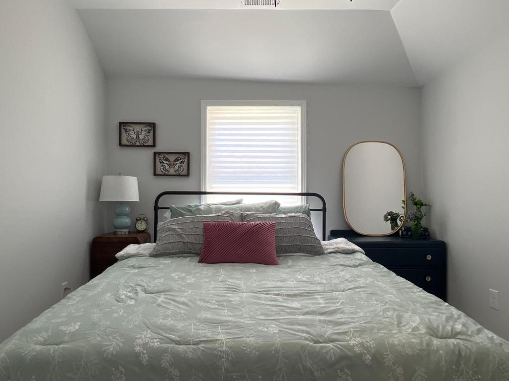 a bedroom with a large bed with a red pillow at 5BR 4B Huge Space with 2 Level Game Barn in Greenville