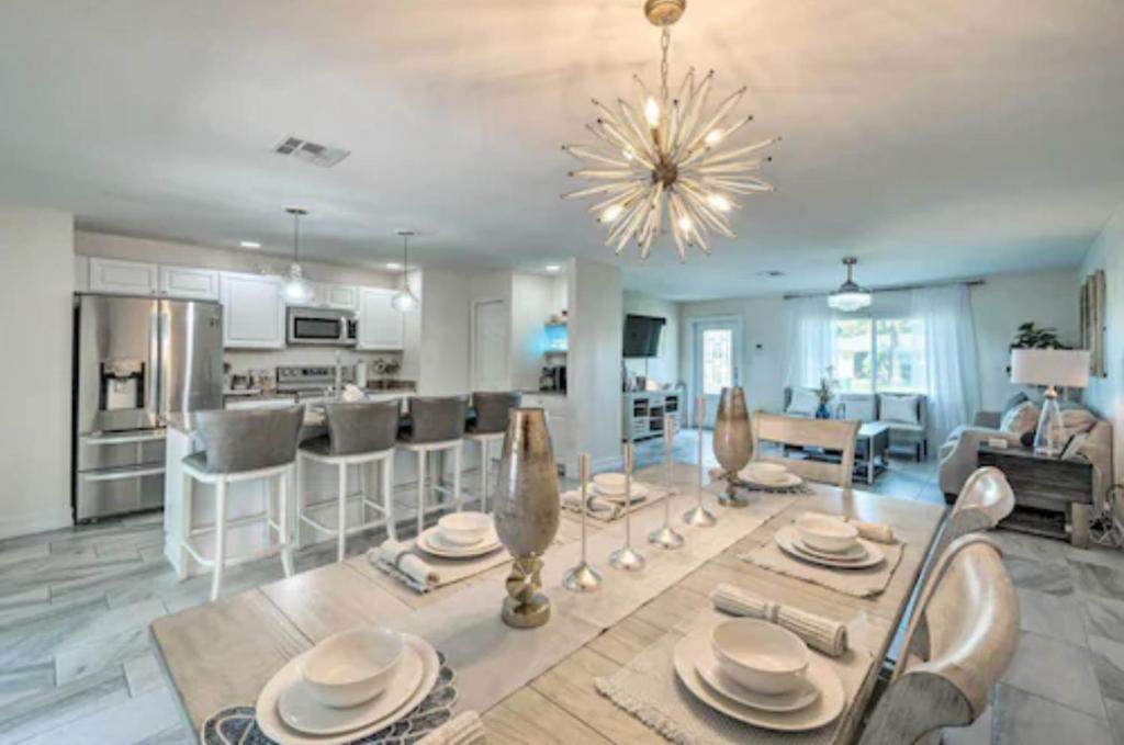 a kitchen and living room with a table and chairs at Luxury modern home Heated pool best Location in Port Charlotte