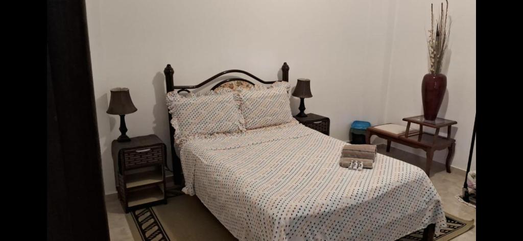 a bedroom with a bed and two lamps and a chair at House the Dream in Curitiba