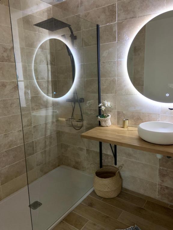 a bathroom with a shower with a sink and two mirrors at LE REFUGE DE LA BAIE in Beaussais sur Mer