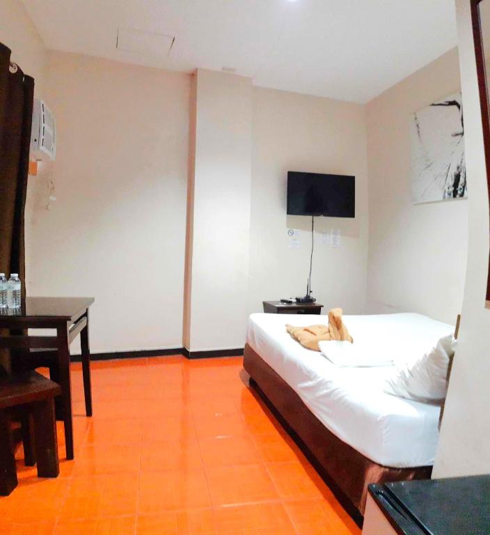 Postel nebo postele na pokoji v ubytování Hotel California Suite