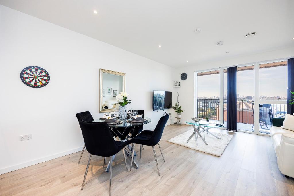 a white living room with a table and chairs at Offers Available - 2 Bed Apartment Business Relocation London City Airport in London