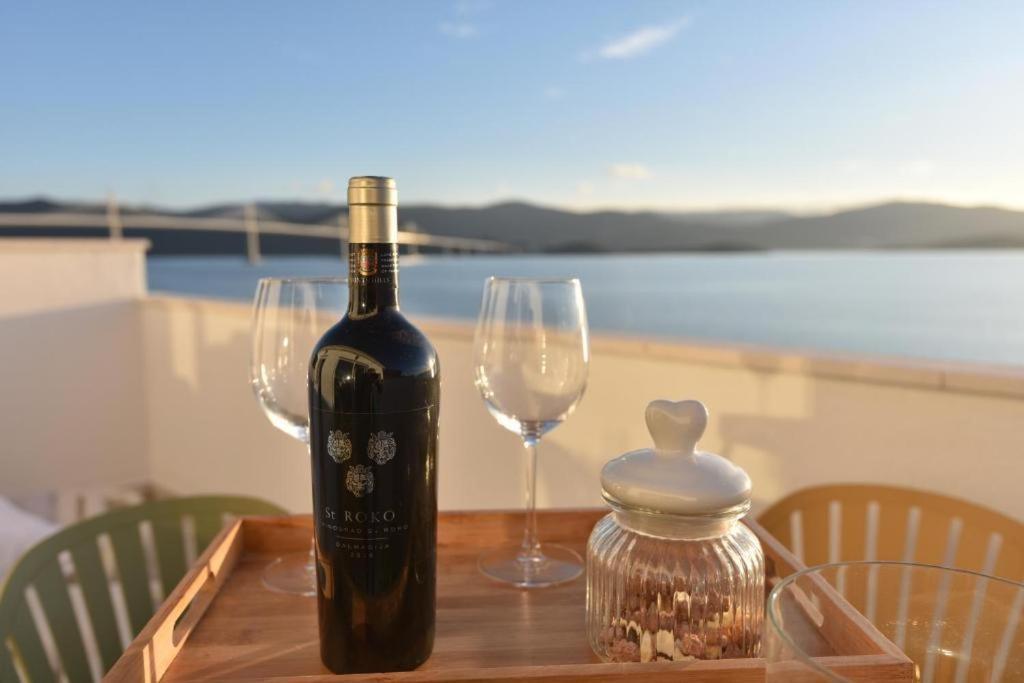 a bottle of wine and two glasses on a table at Butique Maris in Komarna