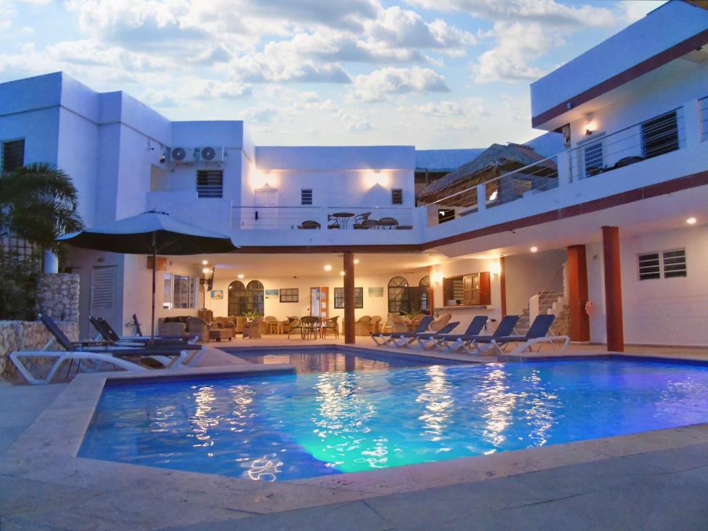 a villa with a swimming pool in front of a house at Boca Simon Vacation Curacao in Willemstad