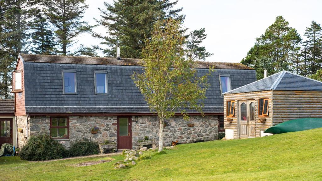 a stone house with a slate roof at The High Croft in Rogart