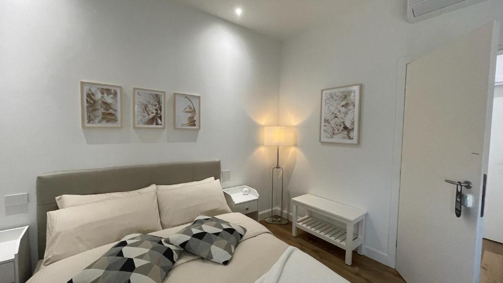 a bedroom with a bed and a lamp and pictures on the wall at Cozy Living Bergamo in Seriate