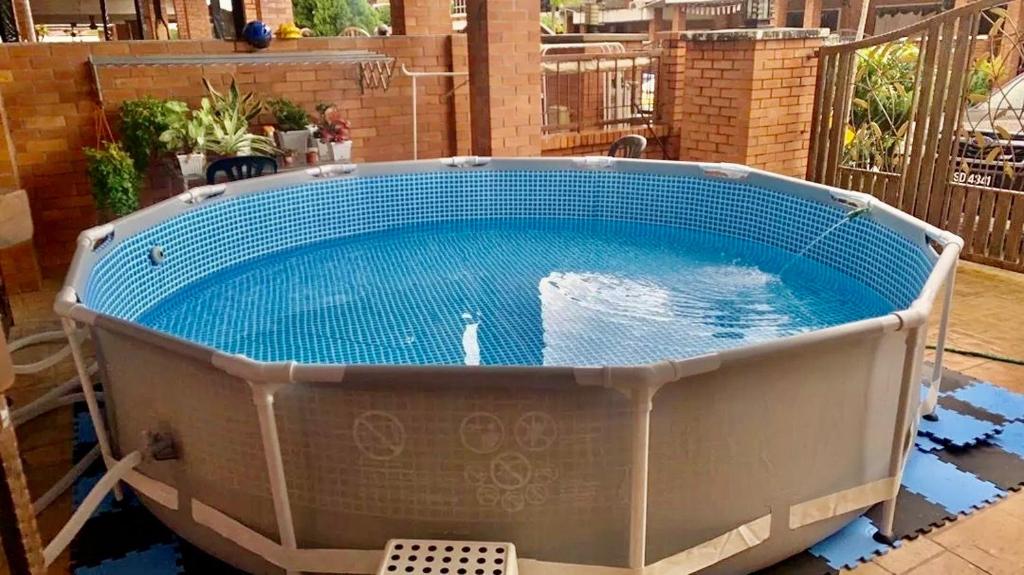 a large hot tub sitting on a patio at Luxurious Villa with BBQ & JACUZZI By The Beach Batu Ferringhi in Batu Ferringhi