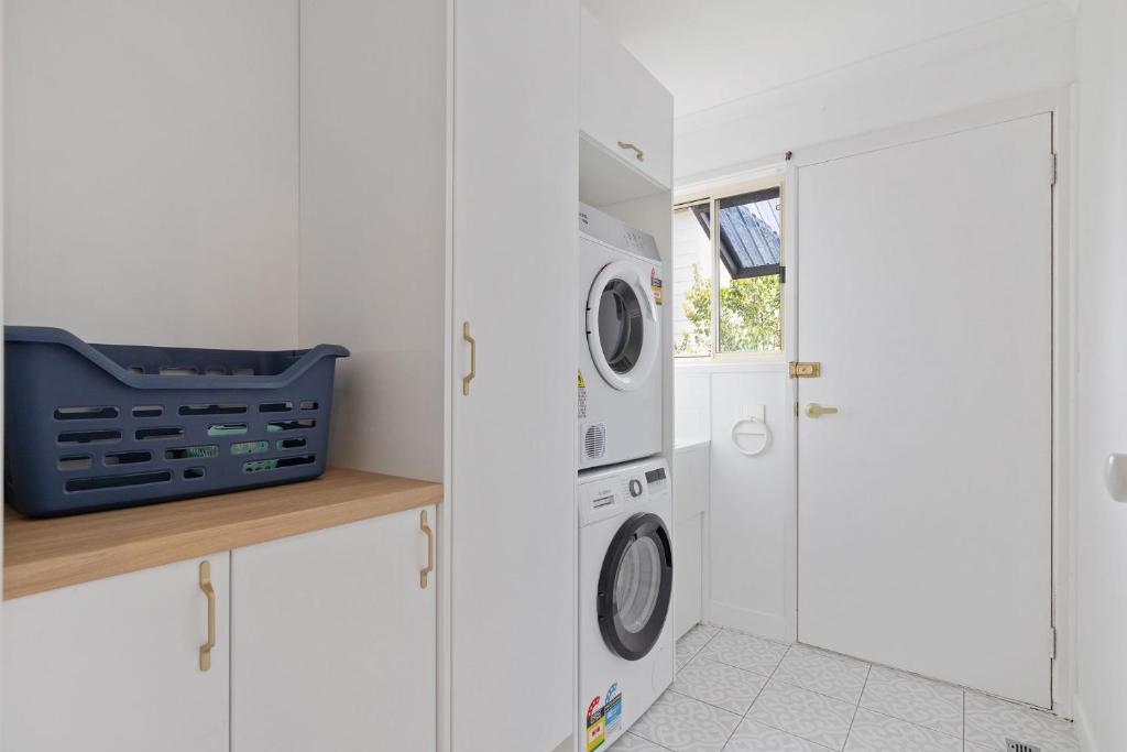 a white laundry room with a washer and dryer at Lazy Daze at SummerHaze in Cape Woolamai