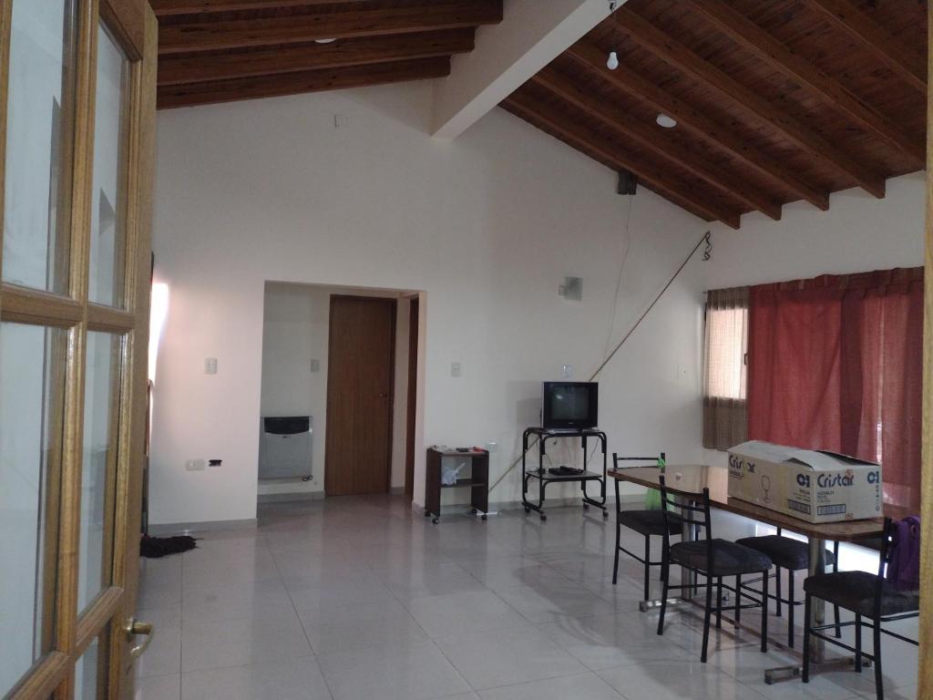 ein Wohnzimmer mit einem Tisch, Stühlen und einem TV in der Unterkunft Casa Obrien in Barraquero