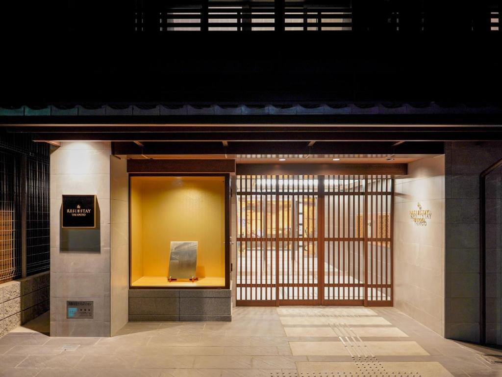 an entrance to a building with a yellow wall at RESI STAY THE KYOTO in Kyoto