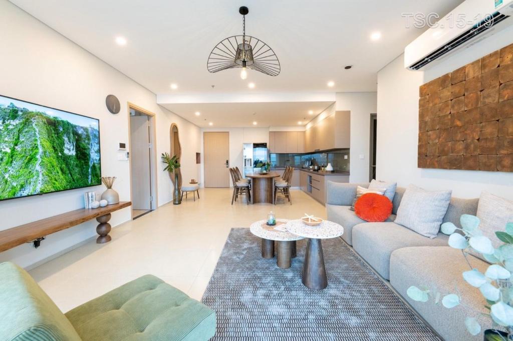 a living room with a couch and a table at The Song Vũng Tàu - Luxury House in Vung Tau