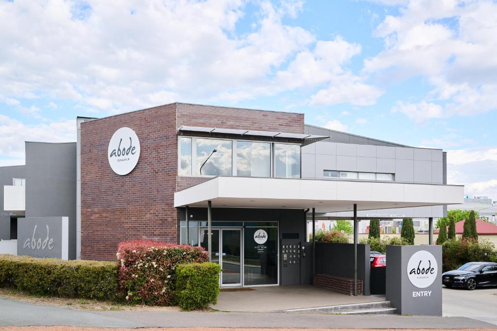 a building with a car parked in front of it at Abode Gungahlin in Canberra