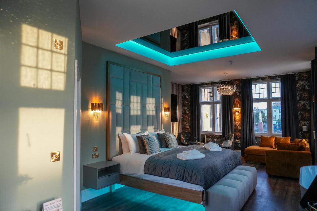 a bedroom with a bed and a blue light at The Arundell Hotel in Boston