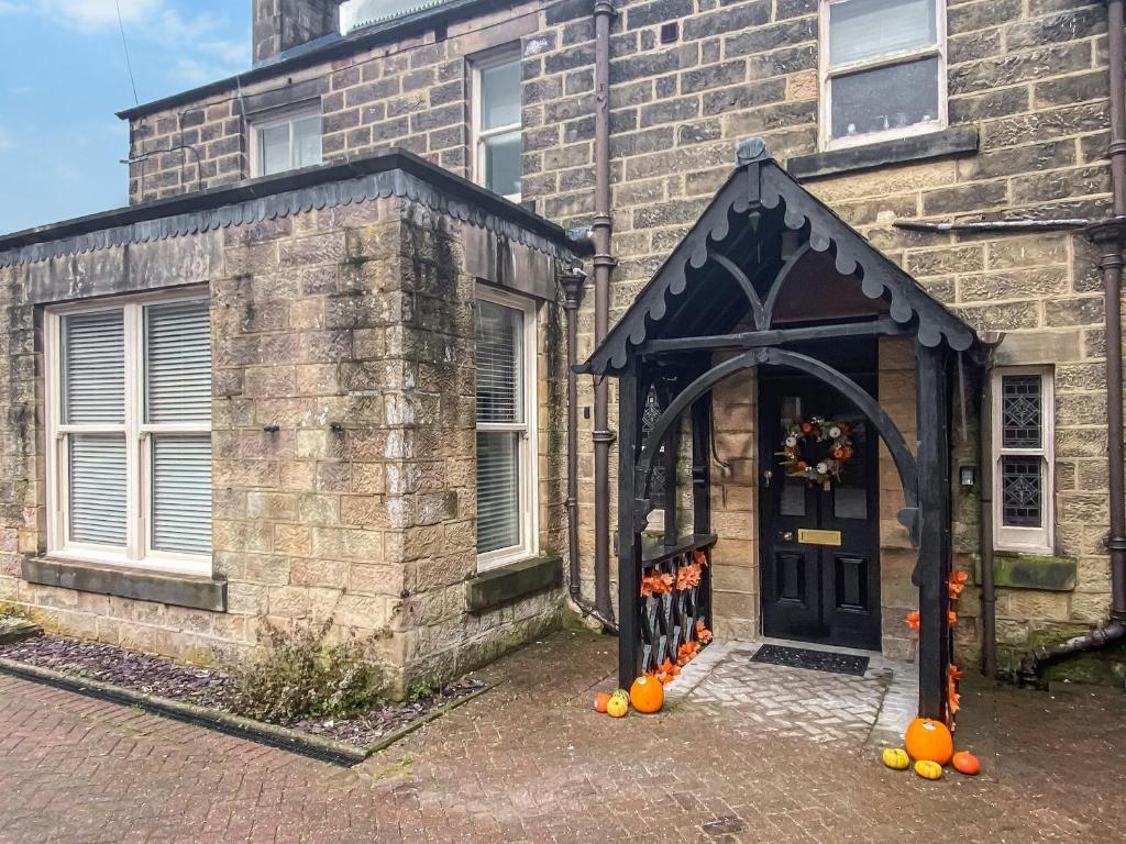 an entrance to a brick building with a pumpkin display at Frankfurt Flat - Uk44457 in Two Dales