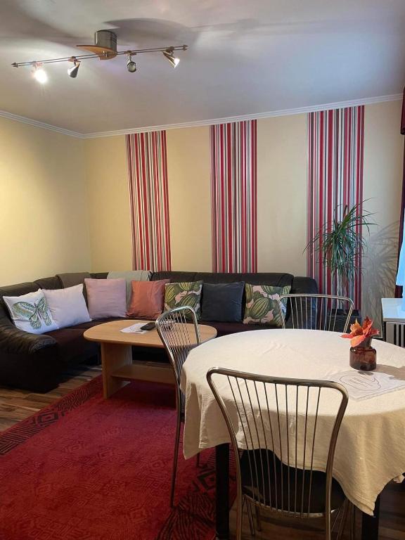 a living room with a couch and a table and chairs at Dizike Pet-friendly Guesthouse in Budapest