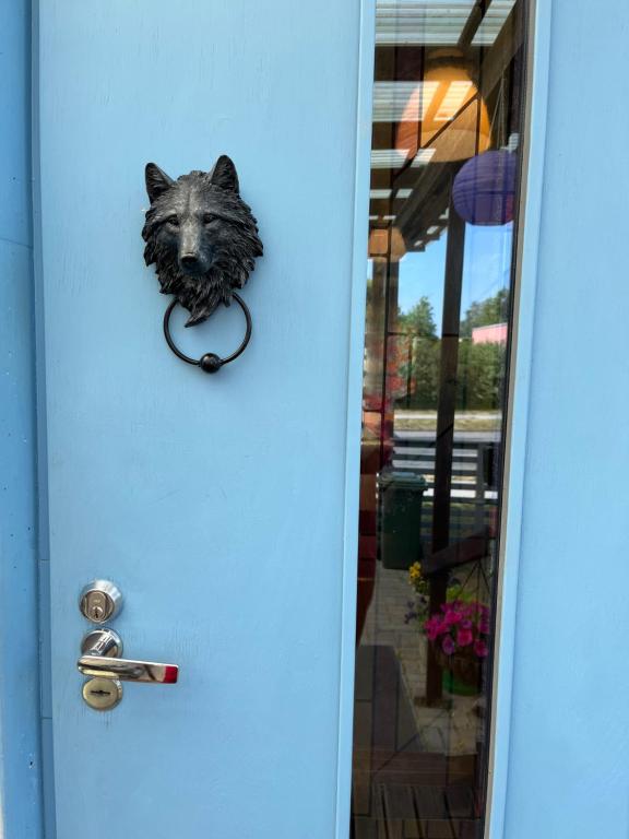 a door with a wolf head head holder on it at Cosy house in Center of Tartu in Tartu