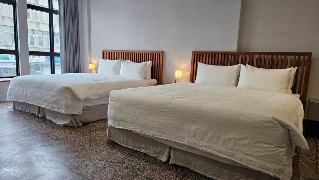 Postel nebo postele na pokoji v ubytování 璿 旅 Syuan Hotel