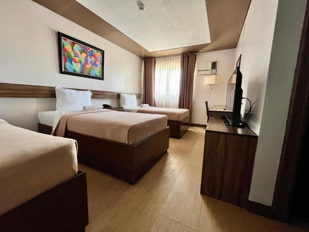 Postel nebo postele na pokoji v ubytování Leope Hotel