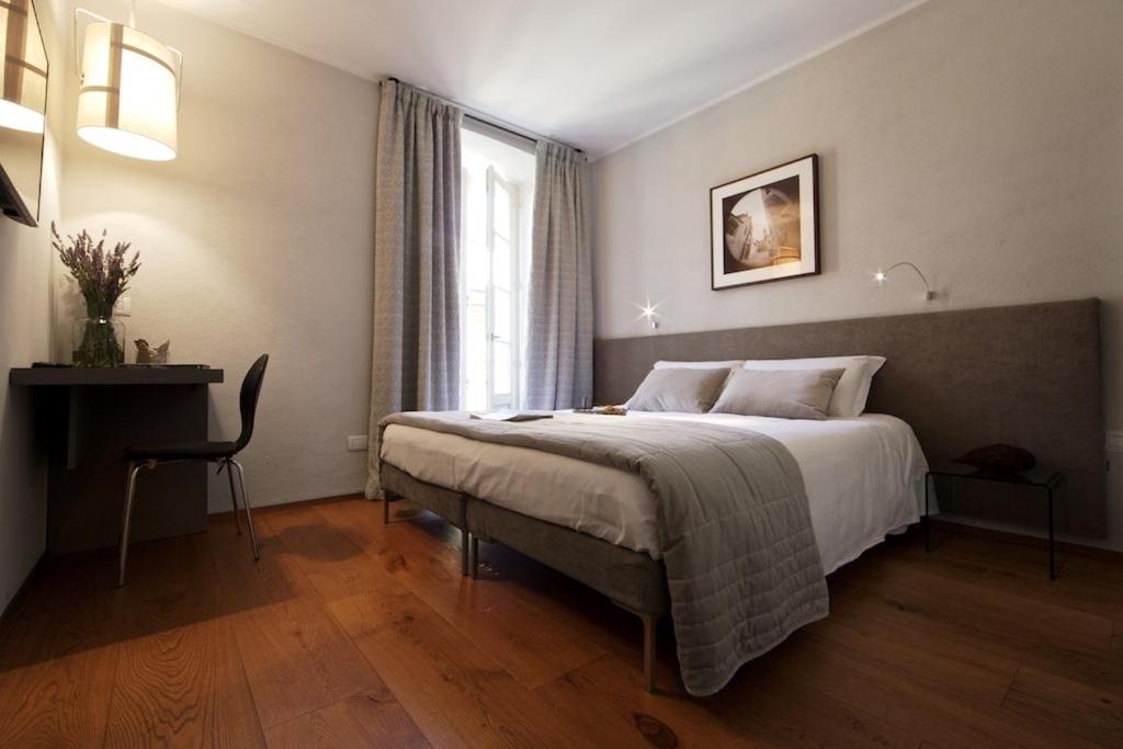 a bedroom with a large bed and a window at Ma Ville in Aosta